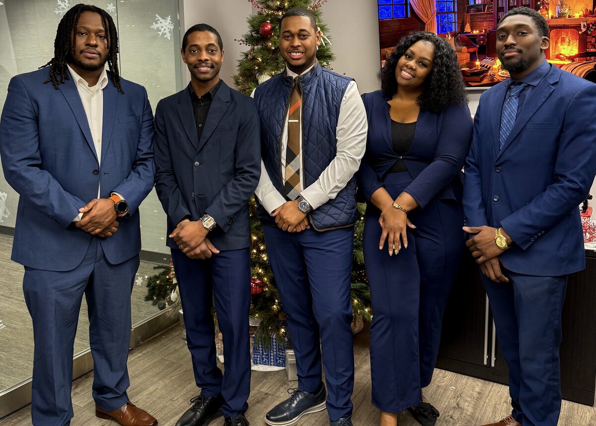 The Capacity Expansion Co team standing together in professional attire in Grand Rapids, Michigan