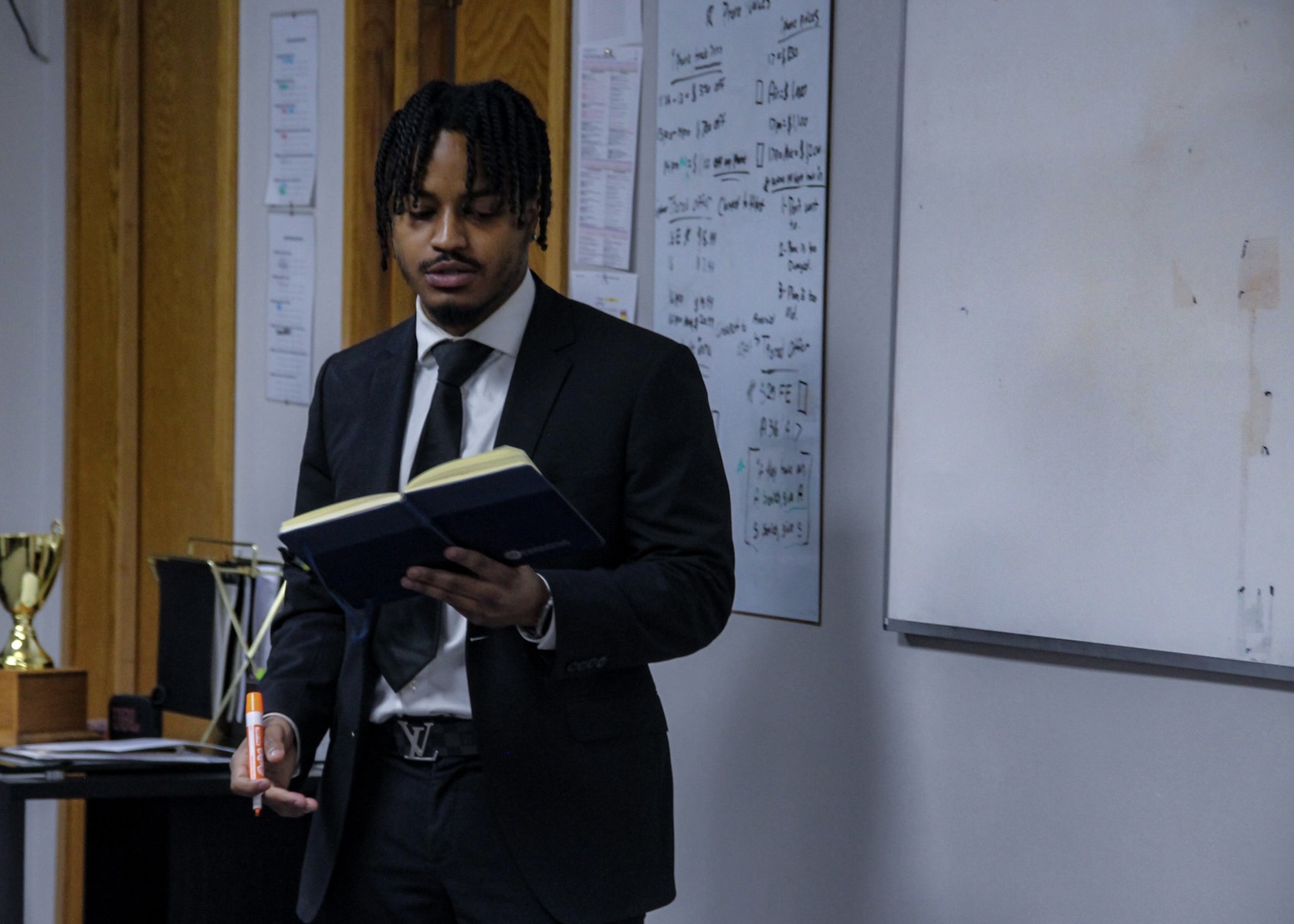 Team member reviewing notes and preparing for a presentation in the office